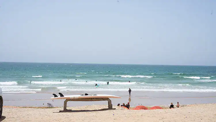 The sea and a surfboard at the beach in Taghazout.