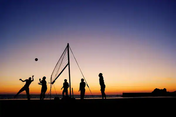 People practicing volley at beach in Taghazout.
